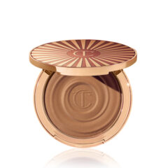 Luxe bronzerpoeder in goudkleurige compact met zonnestraalmotief, perfect voor een stralende gloed.