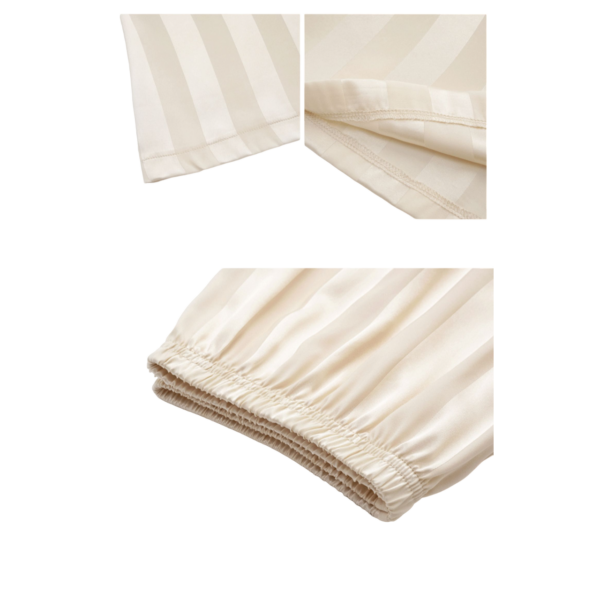 Zijde crèmekleurige blouse-detail met stiksels en elastische mouw voor een elegante uitstraling.