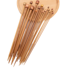 Houten breinaalden op een ronde schaal, variërend in grootte, ideaal voor breiprojecten en handwerk.