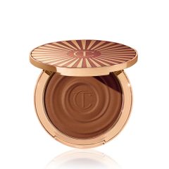 Luxe bronzing compact met goudkleurige verpakking en stralend zonpatroon op de deksel, ideaal voor een stralende teint.